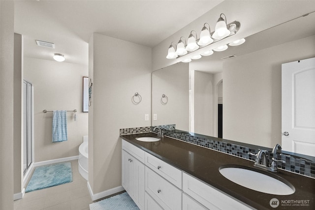 4415 Goldcrest Dr NW, Olympia, WA 98502 - bathroom featuring a freestanding tub, double vanity, tile patterned flooring, baseboards, and a stall shower