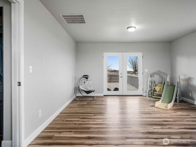13576 NE Rd 10, Moses Lake, WA 98837 - unfurnished room with french doors, wood finished floors, and baseboards