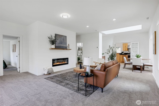 8010 Beverly Blvd Unit A, Everett, WA 98203 - carpeted living area featuring a glass covered fireplace, baseboards, a skylight, and recessed lighting