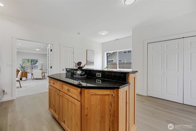 8010 Beverly Blvd Unit A, Everett, WA 98203 - kitchen featuring light wood-style floors, a kitchen island, dark stone counters, recessed lighting, and baseboards