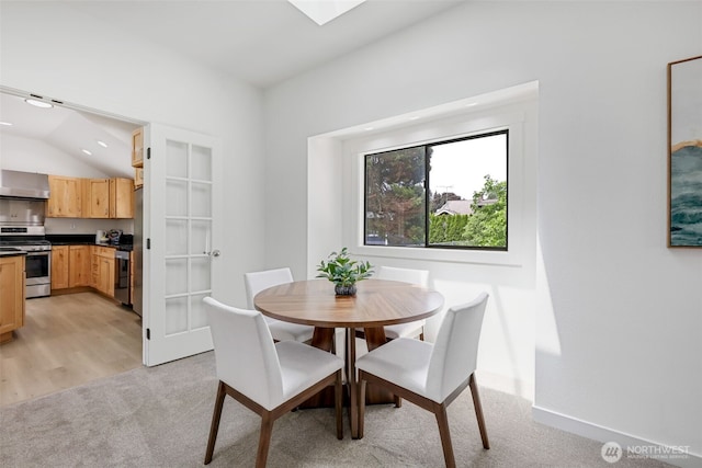 8010 Beverly Blvd Unit A, Everett, WA 98203 - dining area featuring light colored carpet, recessed lighting, lofted ceiling, baseboards, and a skylight