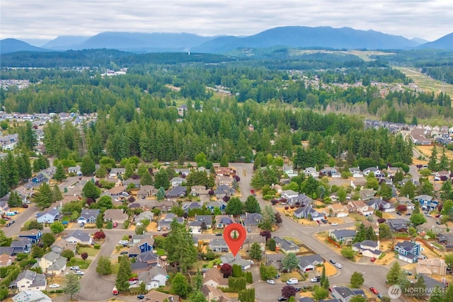 27772 213th Ct SE, Maple Valley, WA 98038 - aerial perspective of suburban area featuring a mountainous background and a heavily wooded area