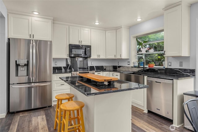 27772 213th Ct SE, Maple Valley, WA 98038 - kitchen with appliances with stainless steel finishes, dark wood-style flooring, a center island, white cabinets, and recessed lighting