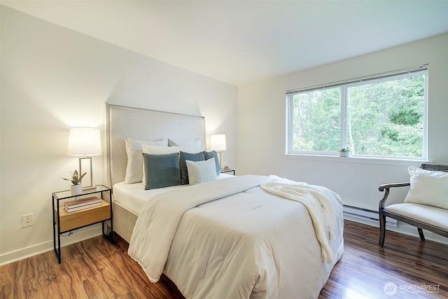 12019 NE 204th Pl Unit D303, Bothell, WA 98011 - bedroom with wood finished floors, baseboard heating, and baseboards