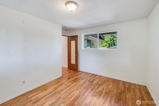 11319 86th Ave E, Puyallup, WA 98373 - unfurnished room featuring light wood-style floors and baseboards