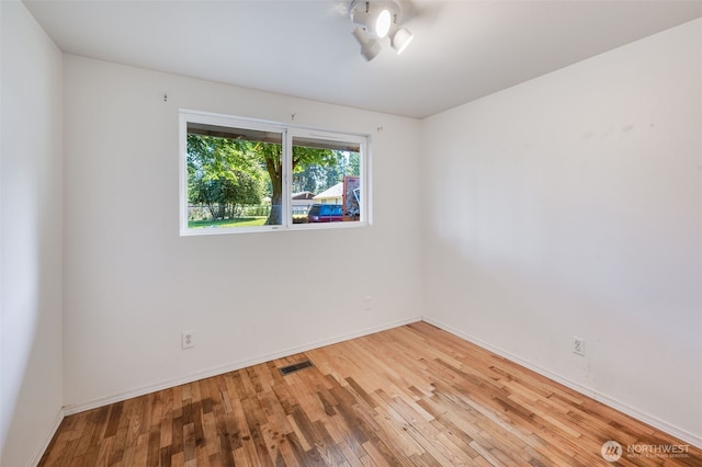 11319 86th Ave E, Puyallup, WA 98373 - spare room featuring wood finished floors and baseboards