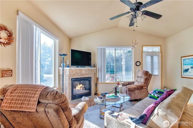 152 N Oar Loop NW, Ocean Shores, WA 98569 - living area with wood finished floors, healthy amount of natural light, a tiled fireplace, vaulted ceiling, and ceiling fan