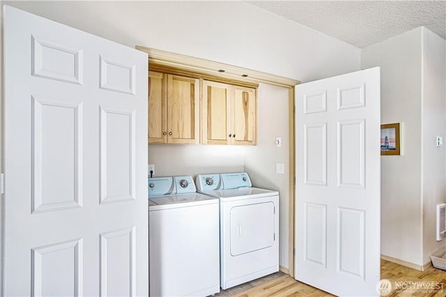 152 N Oar Loop NW, Ocean Shores, WA 98569 - washroom featuring washing machine and clothes dryer, cabinet space, light wood finished floors, and baseboards