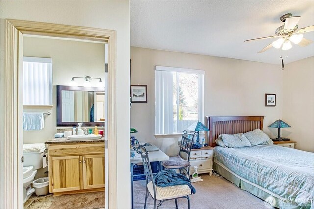 152 N Oar Loop NW, Ocean Shores, WA 98569 - bedroom with light carpet, a sink, and a ceiling fan