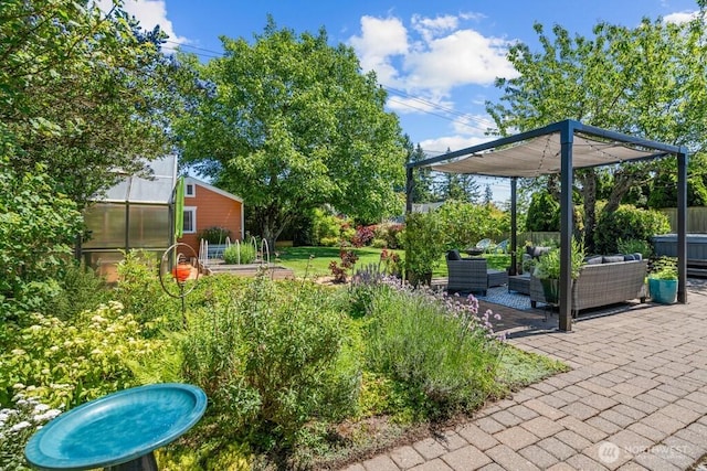 8414 34th Ave SW, Seattle, WA 98126 - view of yard featuring a greenhouse, an outdoor hangout area, an outbuilding, a patio, and a vegetable garden