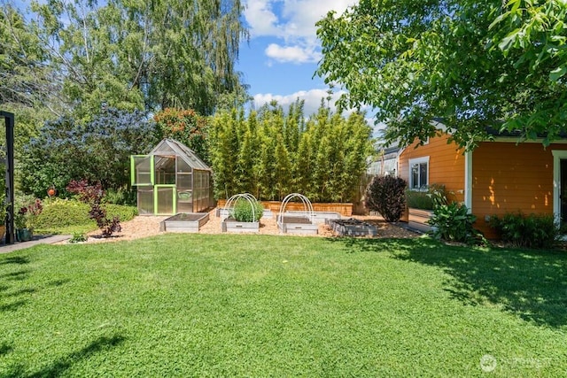 8414 34th Ave SW, Seattle, WA 98126 - view of green lawn featuring a garden, an exterior structure, and an outbuilding