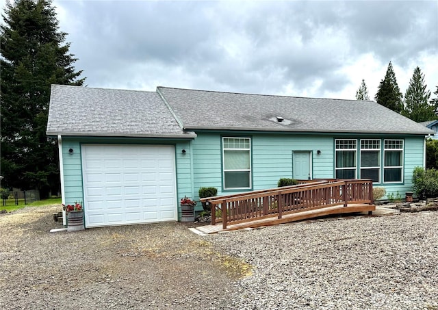 173 Steelhead Dr, Silver Creek, WA 98585 - rear view of property with gravel driveway, a garage, a wooden deck, and a shingled roof