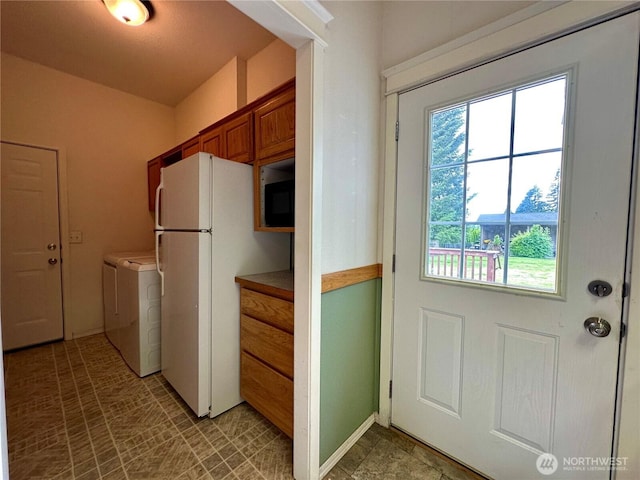 173 Steelhead Dr, Silver Creek, WA 98585 - kitchen with freestanding refrigerator, washing machine and dryer, brown cabinetry, and built in microwave