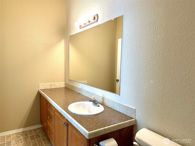 173 Steelhead Dr, Silver Creek, WA 98585 - bathroom with vanity, toilet, and baseboards