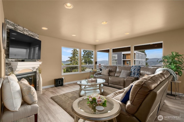 11031 Cornell Ave S, Seattle, WA 98178 - living room with a large fireplace, baseboards, light wood finished floors, and recessed lighting