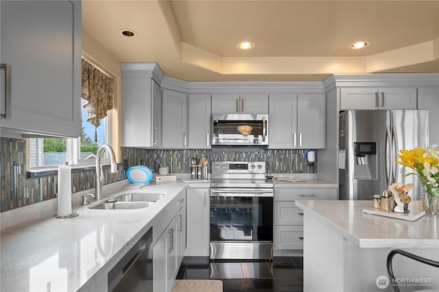 11031 Cornell Ave S, Seattle, WA 98178 - kitchen featuring stainless steel appliances, a sink, backsplash, recessed lighting, and a tray ceiling
