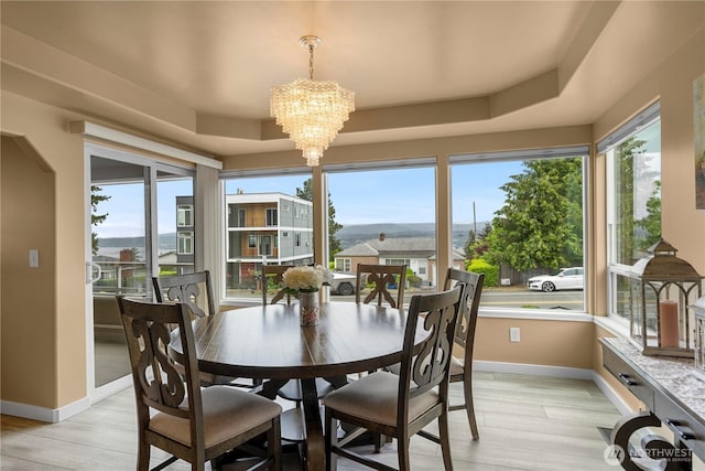 11031 Cornell Ave S, Seattle, WA 98178 - dining room featuring a chandelier, baseboards, light wood-type flooring, and a raised ceiling