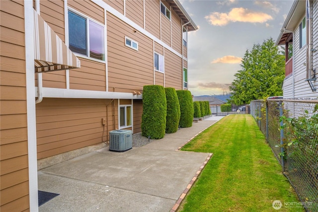 11031 Cornell Ave S, Seattle, WA 98178 - yard at dusk with central AC and a patio