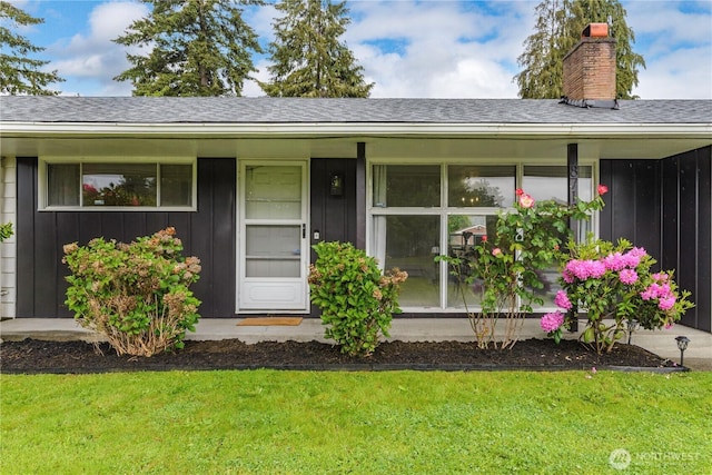 8718 Hipkins Rd SW, Lakewood, WA 98498 - view of front facade featuring board and batten siding, a chimney, a shingled roof, and a front lawn