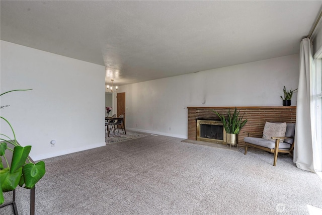 8718 Hipkins Rd SW, Lakewood, WA 98498 - unfurnished living room with a chandelier, carpet, a fireplace, and baseboards