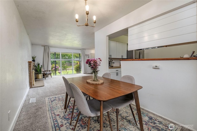 8718 Hipkins Rd SW, Lakewood, WA 98498 - dining space with a chandelier, light carpet, and baseboards