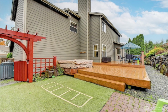14531 86th Pl NE, Kenmore, WA 98028 - back of property featuring a hot tub, a deck, a chimney, and outdoor dining area