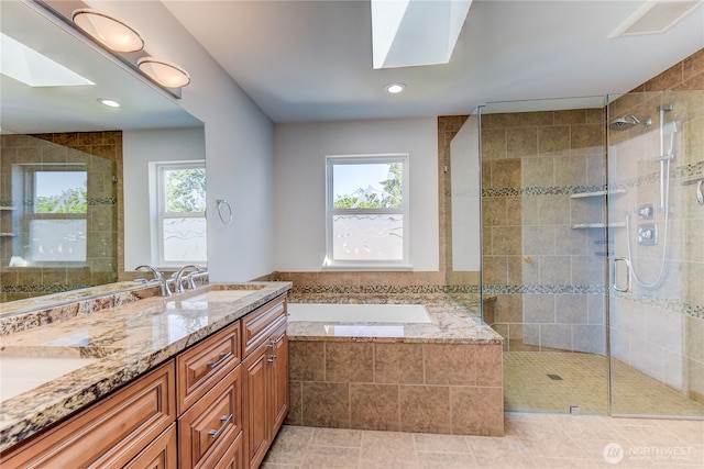 14531 86th Pl NE, Kenmore, WA 98028 - full bathroom with a skylight, a bath, a stall shower, double vanity, and recessed lighting