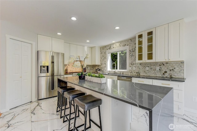 14531 86th Pl NE, Kenmore, WA 98028 - kitchen featuring appliances with stainless steel finishes, light marble finish floors, recessed lighting, backsplash, and a center island