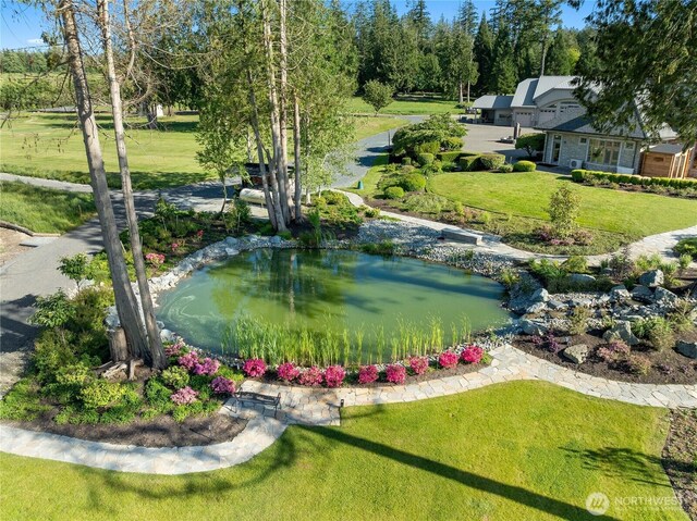 33020 84th Ave NW, Stanwood, WA 98292 - view of home's community featuring a lawn and a small pond