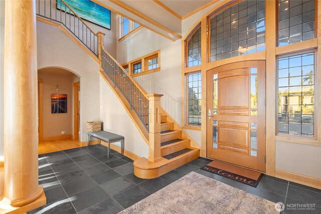33020 84th Ave NW, Stanwood, WA 98292 - entrance foyer featuring baseboards, arched walkways, healthy amount of natural light, crown molding, and a high ceiling