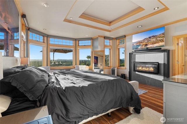 33020 84th Ave NW, Stanwood, WA 98292 - bedroom with crown molding, wood finished floors, a tile fireplace, a raised ceiling, and recessed lighting