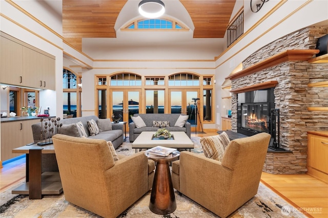 33020 84th Ave NW, Stanwood, WA 98292 - living area with high vaulted ceiling, wood ceiling, a fireplace, light wood finished floors, and french doors
