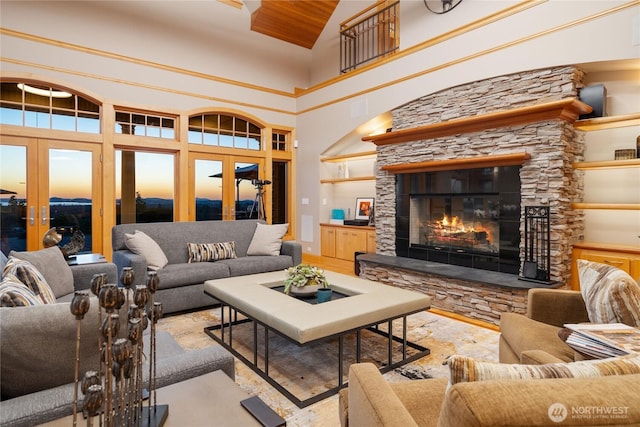 33020 84th Ave NW, Stanwood, WA 98292 - living area with french doors, a towering ceiling, a stone fireplace, and wood finished floors