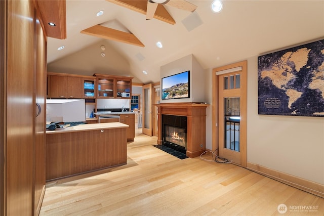 33020 84th Ave NW, Stanwood, WA 98292 - kitchen with brown cabinetry, light wood-type flooring, glass insert cabinets, a ceiling fan, and a peninsula