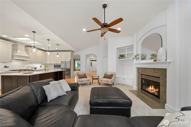 8122 104th Street Ct SW, Lakewood, WA 98498 - living area with recessed lighting, a ceiling fan, arched walkways, light carpet, and a tile fireplace