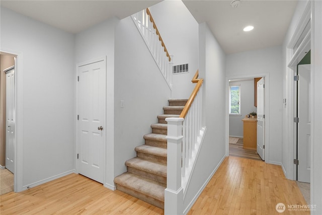 8122 104th Street Ct SW, Lakewood, WA 98498 - staircase with wood finished floors, baseboards, and recessed lighting
