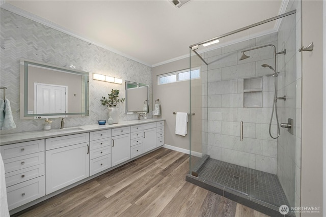 8122 104th Street Ct SW, Lakewood, WA 98498 - bathroom with ornamental molding, double vanity, a stall shower, wood finished floors, and baseboards