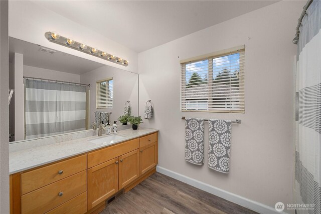 8122 104th Street Ct SW, Lakewood, WA 98498 - bathroom featuring vanity, wood finished floors, baseboards, and a heating unit