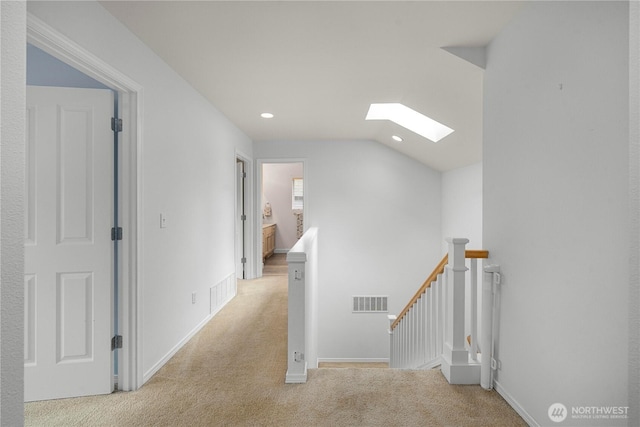 8122 104th Street Ct SW, Lakewood, WA 98498 - hall with an upstairs landing, a skylight, light colored carpet, lofted ceiling, and recessed lighting