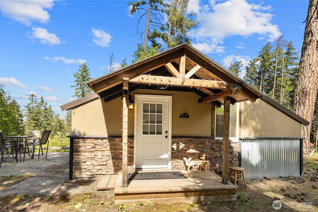 131 Horse Heaven Rd, Cle Elum, WA 98922 - view of exterior entry featuring stone siding, stucco siding, and a patio