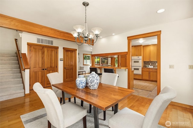 14427 Silven Ave NE, Bainbridge Island, WA 98110 - dining room with stairs, a chandelier, recessed lighting, and light wood finished floors