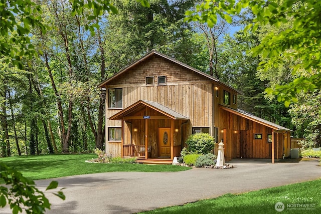 14427 Silven Ave NE, Bainbridge Island, WA 98110 - chalet / cabin with driveway, a front yard, and a carport
