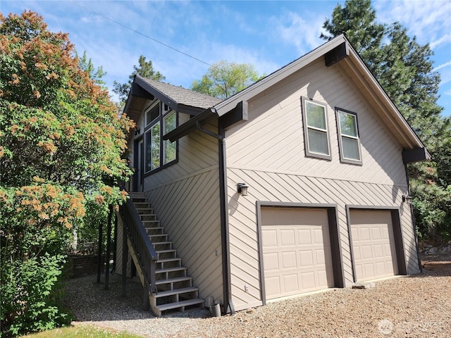 56 Westlake Rd, Oroville, WA 98844 - view of home's exterior featuring a garage, stairs, and dirt driveway