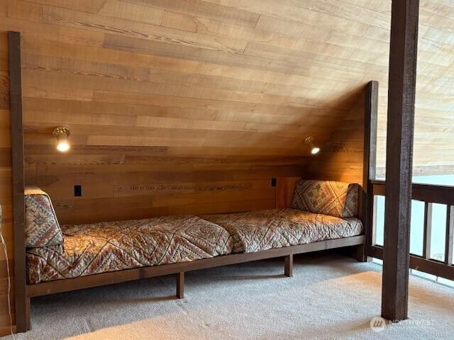 56 Westlake Rd, Oroville, WA 98844 - bedroom featuring wood walls, carpet flooring, vaulted ceiling, and wooden ceiling