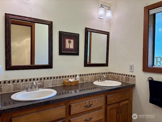 56 Westlake Rd, Oroville, WA 98844 - bathroom featuring double vanity and decorative backsplash