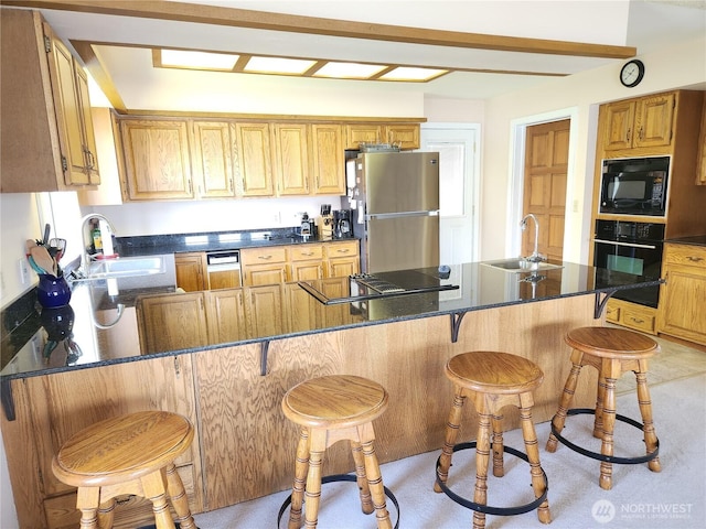 56 Westlake Rd, Oroville, WA 98844 - kitchen with black appliances, a sink, a peninsula, and a kitchen bar