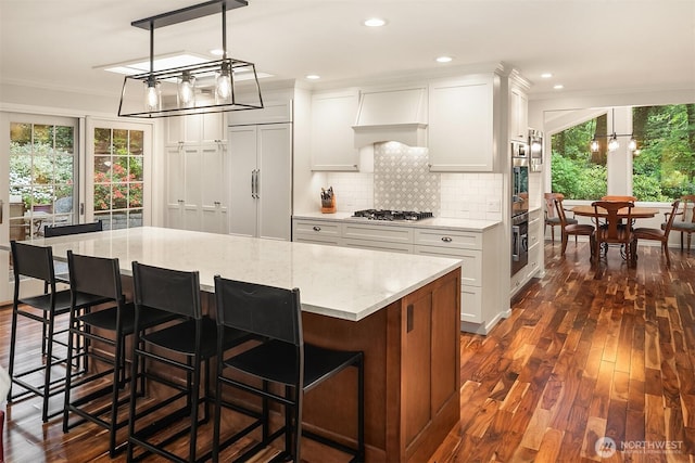 12810 NE 32nd Pl, Bellevue, WA 98005 - kitchen featuring appliances with stainless steel finishes, ornamental molding, white cabinetry, dark wood-style floors, and recessed lighting
