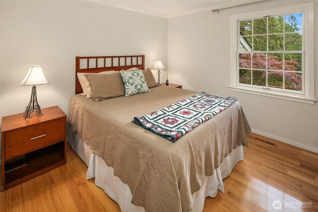 12810 NE 32nd Pl, Bellevue, WA 98005 - bedroom with light wood-style floors, crown molding, and baseboards