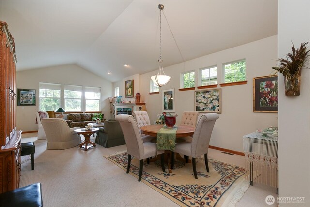 1770 SW Aberdeen Ct, Oak Harbor, WA 98277 - dining area featuring vaulted ceiling, carpet, and a glass covered fireplace