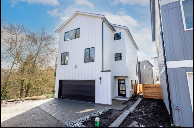 6730 21st Ave SW, Seattle, WA 98106 - modern farmhouse style home with an attached garage, board and batten siding, and decorative driveway